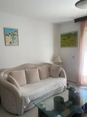a living room with a couch and a glass table at Darkobd in Budva