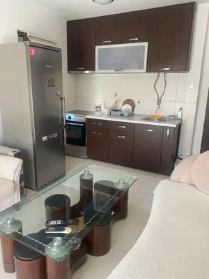 a kitchen with a glass table and a stainless steel refrigerator at Darkobd in Budva