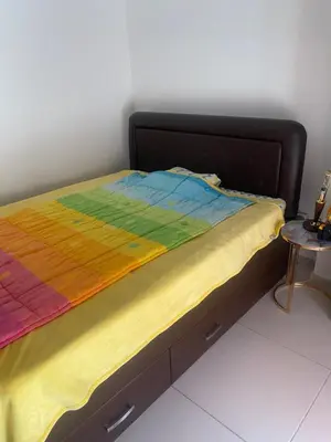 a bed with a colorful blanket on top of it at Darkobd in Budva