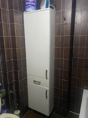 a small white cabinet in a bathroom with a toilet at Darkobd in Budva