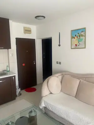 a living room with a couch and a glass table at Darkobd in Budva