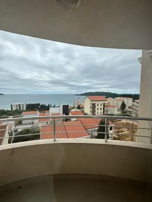 a balcony with a view of the ocean and buildings at Apartment Sea Point in Becici