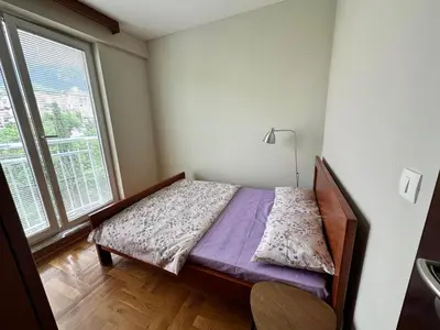 a small bedroom with a bed and a window at Apartment Sea Point in Becici