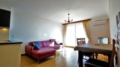 a living room with a red couch and a table at Apartment Sea Point in Becici