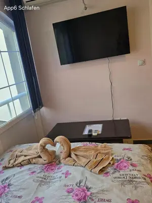 a bed with a towel in the shape of a heart at Sveti Georgie Apartments in Becici