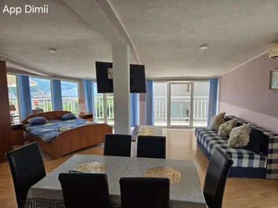 a living room with a bed and a dining table at Sveti Georgie Apartments in Becici