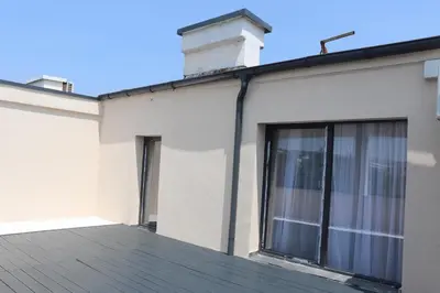 a house with a window and a roof at Loft Apartment in Podgorica