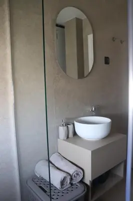 a bathroom with a sink and a mirror at Loft Apartment in Podgorica