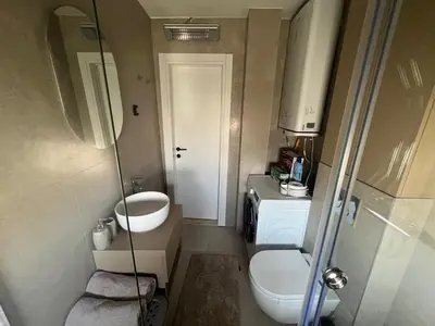 a small bathroom with a toilet and a sink at Loft Apartment in Podgorica
