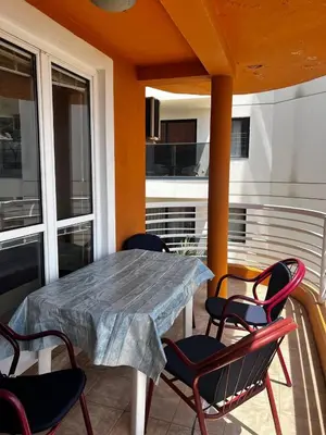 a patio with a table and chairs on a balcony at Better place in Becici