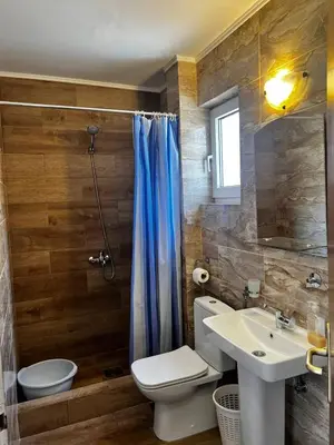 a bathroom with a toilet and a sink and a shower at Better place in Becici