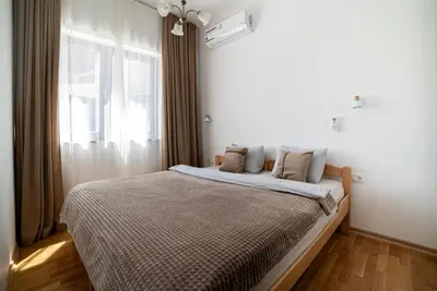 a bedroom with a large bed with a window at The Royal Summer & Spa in Becici