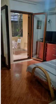 a bedroom with a sliding glass door leading to a patio at Apartment Gala in Budva
