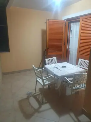 a white table and chairs in a room at Apartment Gala in Budva