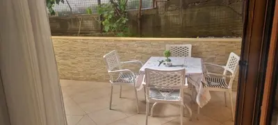 a white table and chairs on a patio at Apartment Gala in Budva