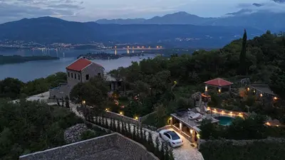 a building on a hill with a view of a river at Villa Diamonte in Ðuraševići