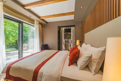 a bedroom with a large bed with pillows and a window at Villa Diamonte in Ðuraševići