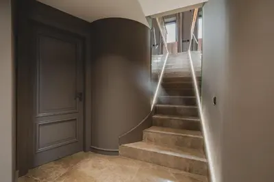 a hallway with stairs with a door and a stair light at Villa Diamonte in Ðuraševići