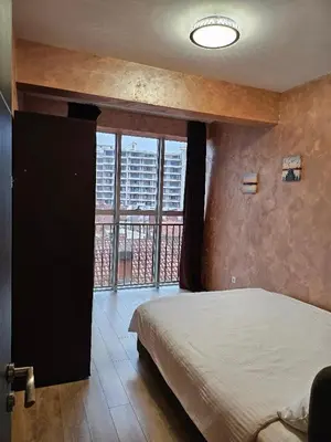 a bedroom with a bed and a large window at Apartmans Budva centar in Budva