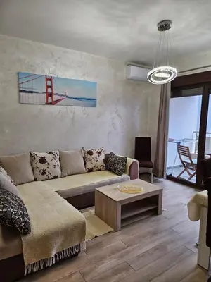 a living room with a couch and a table at Apartmans Budva centar in Budva