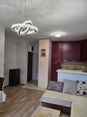 a living room with a couch and a chandelier at Apartmans Budva centar in Budva