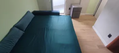 a green couch in a living room at Apartment Cataleya in Budva