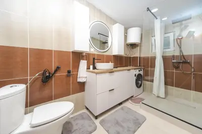 a bathroom with a toilet and a sink and a mirror at Apartment Cataleya in Budva