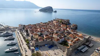 an aerial view of a town with boats in the water at Hotel Atina in Budva