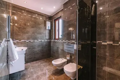 a bathroom with a toilet and a sink at City Apartments in Budva