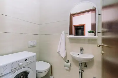 a bathroom with a washing machine and a sink at City Apartments in Budva