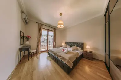 a bedroom with a bed and a window at City Apartments in Budva