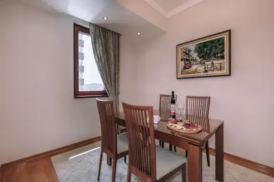 a dining room with a table and chairs and a window at City Apartments in Budva