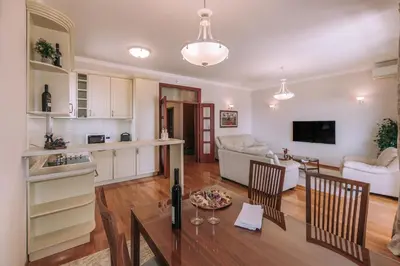 a kitchen and living room with a table and chairs at City Apartments in Budva