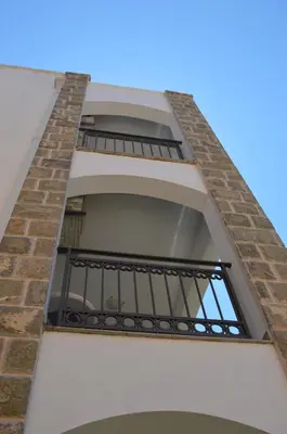 a window in a brick building with a balcony at Apartment Folic Sutomore in Sutomore