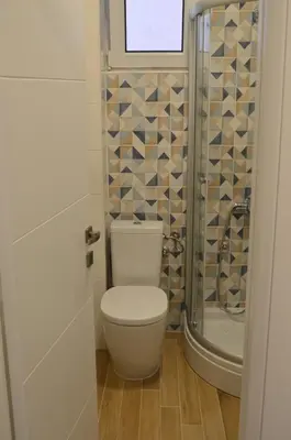 a bathroom with a toilet and a shower at Apartment Folic Sutomore in Sutomore