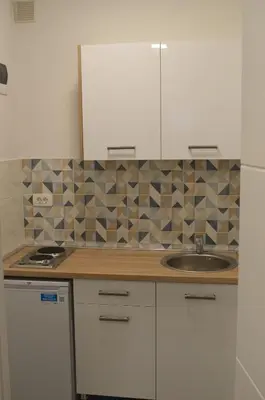 a kitchen with white cabinets and a sink at Apartment Folic Sutomore in Sutomore