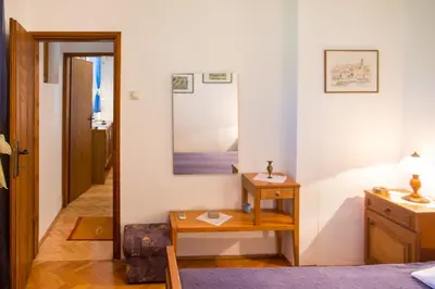a bedroom with a table and a mirror at Azur Apartment in Budva