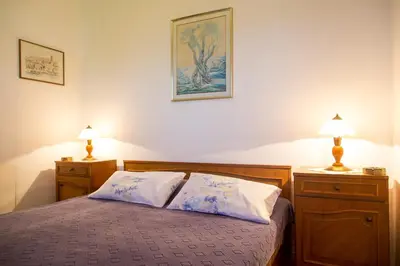 a bedroom with a bed with two night stands and two lamps at Azur Apartment in Budva