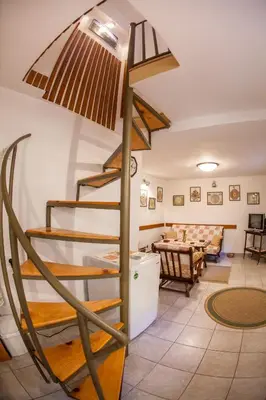 a spiral staircase in a room with a living room at Azur Apartment in Budva