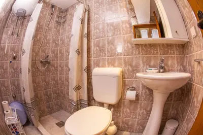 a small bathroom with a toilet and a sink at Azur Apartment in Budva