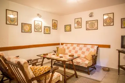 a living room with a couch and a table and chairs at Azur Apartment in Budva