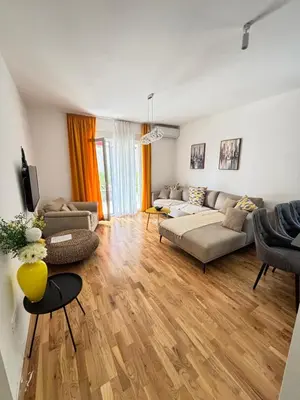 a living room with a couch and a table at Becici Garden in Becici