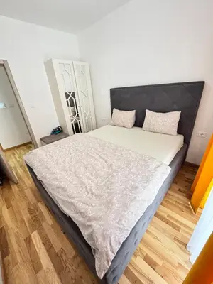 a bedroom with a bed with a black headboard at Becici Garden in Becici