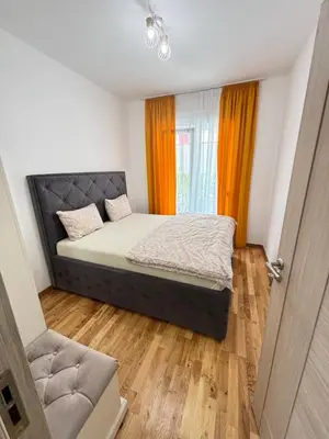 a small bedroom with a bed and a window at Becici Garden in Becici