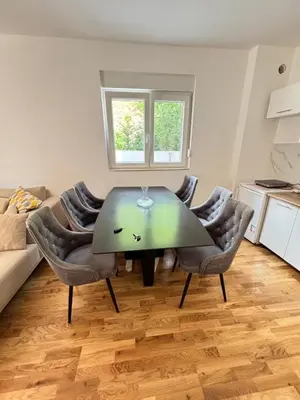 a living room with a table and chairs at Becici Garden in Becici