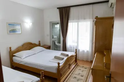 a bedroom with a bed with two towels on it at Villa Duraku in Ulcinj