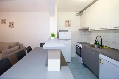 a kitchen with a white counter top in a room at Palm street apartment near Dukley beach in Budva