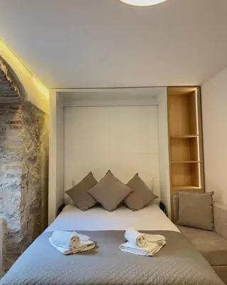 a bedroom with a bed with two towels on it at Casa Del Sol Pietra Kotor in Kotor