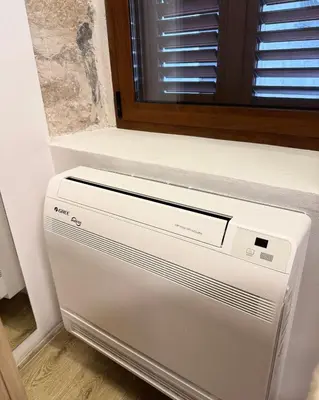 a white refrigerator in a room with a window at Casa Del Sol Pietra Kotor in Kotor