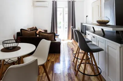 a kitchen and living room with a table and chairs at Green Garden in Tivat